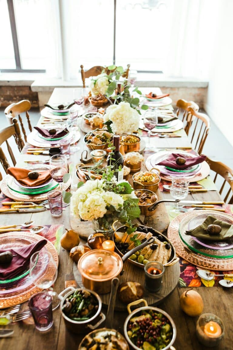 White flowers on a white ceramic plate on a table — fall MetroWest dinner setting