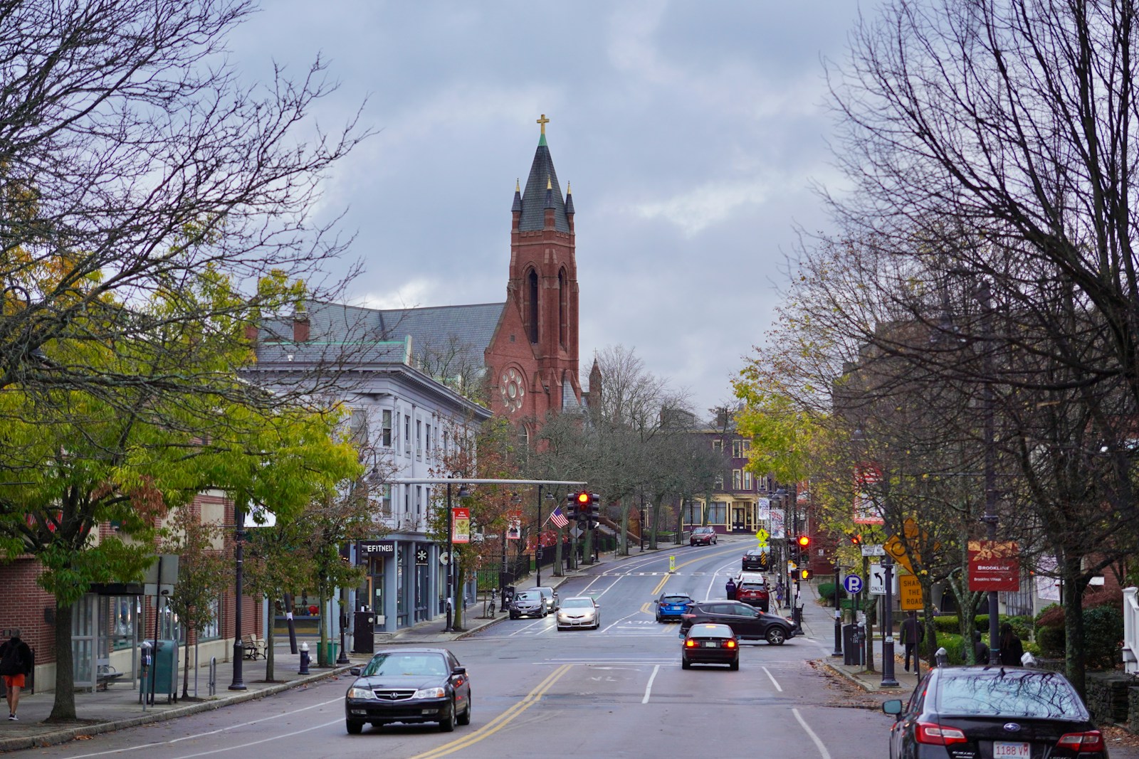 A Brookline street view with a church steeple in the background