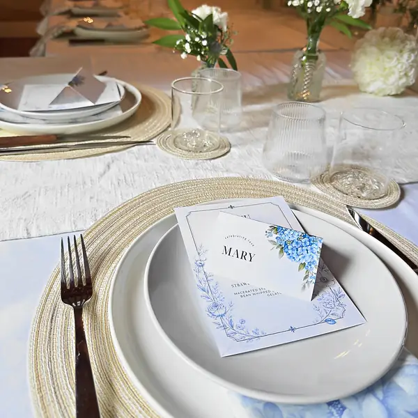 Wedding table setting with printed menu card and blue hydrangea detail, Partum Events